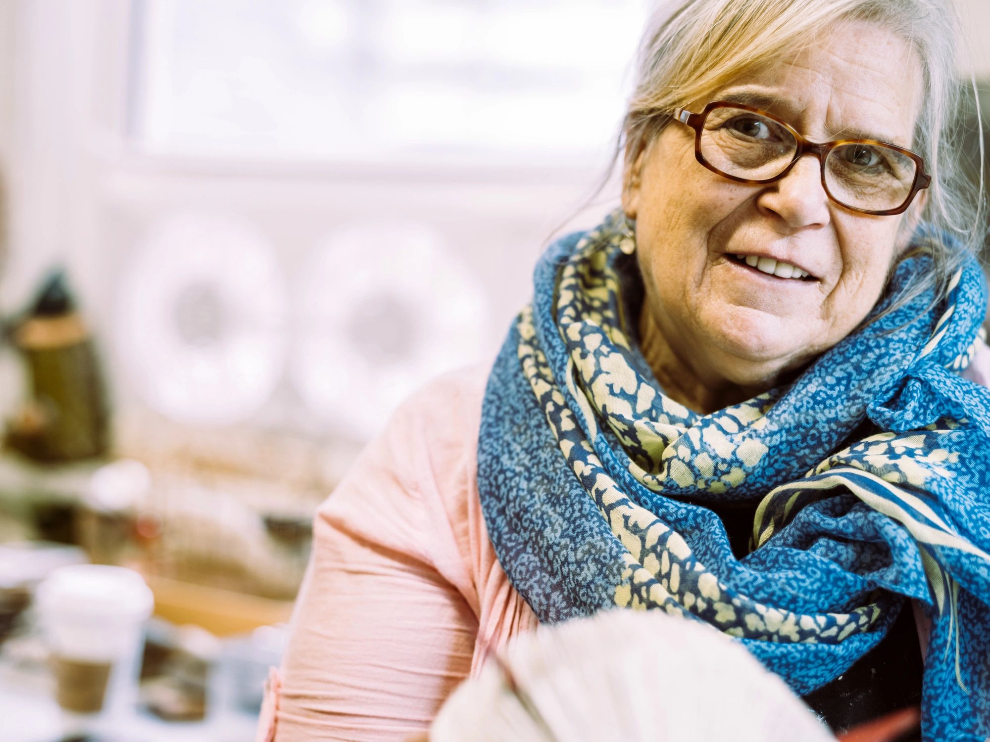 smiling quilting customer with finished quilt