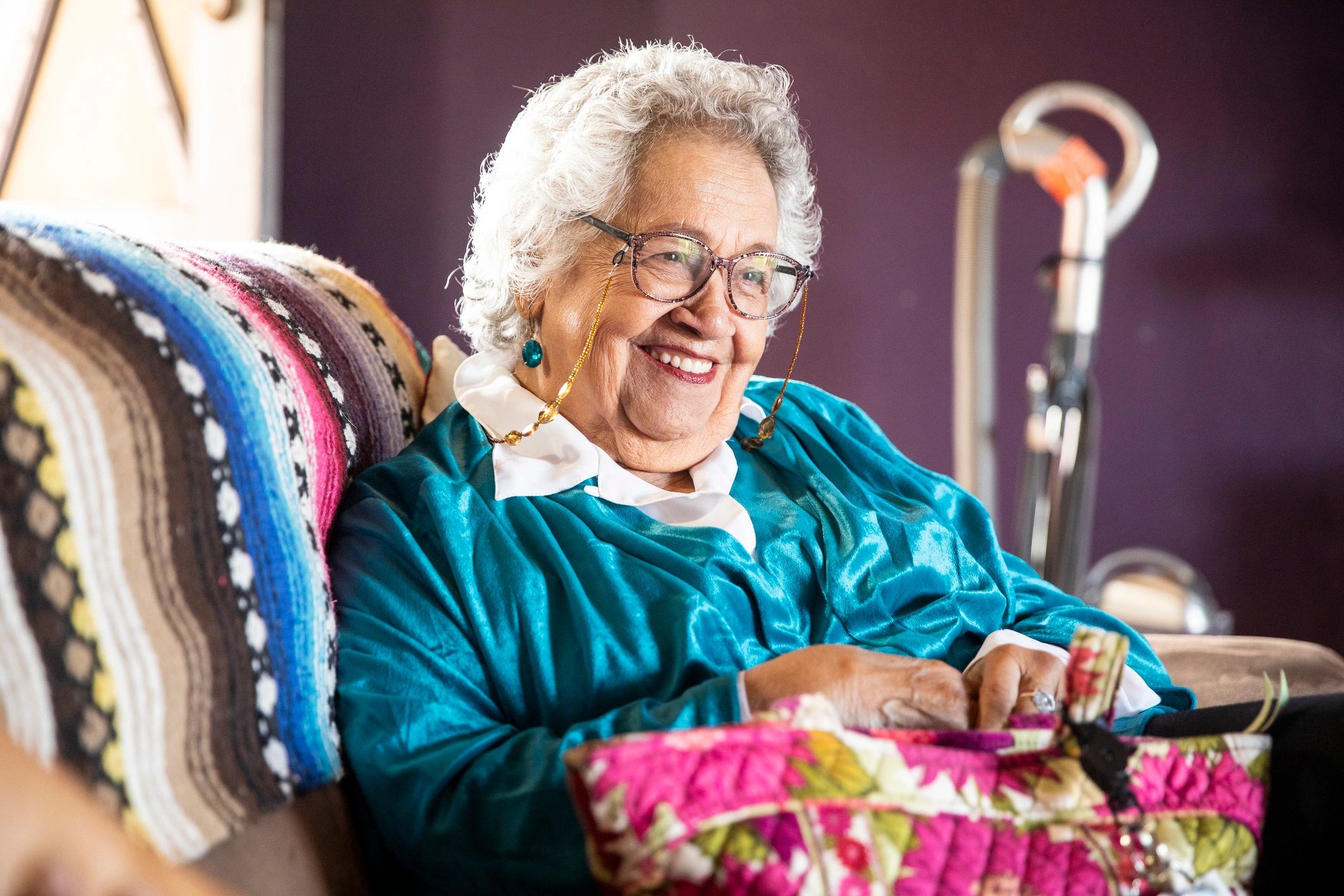 smiling quilting customer with finished quilt